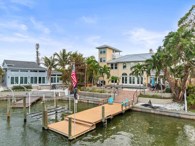 view of dock with a water view and a patio area