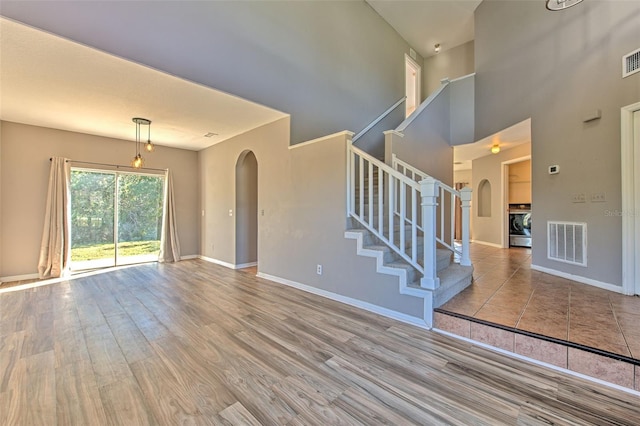 interior space with washer / dryer and light hardwood / wood-style flooring