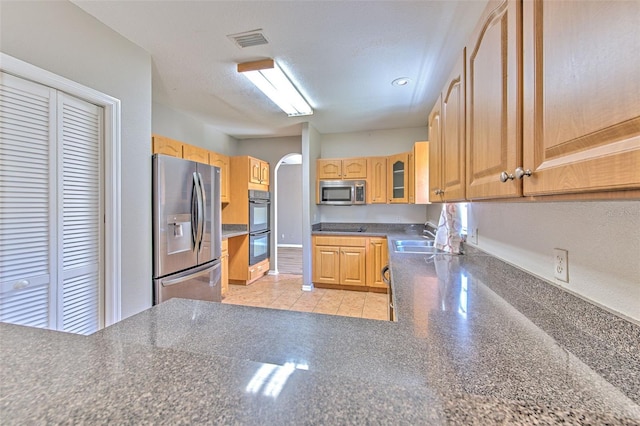 kitchen featuring a textured ceiling, sink, and appliances with stainless steel finishes