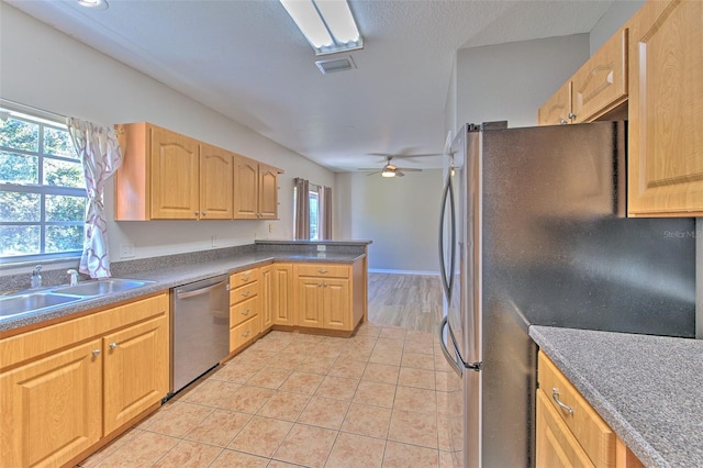 kitchen featuring light brown cabinets, sink, ceiling fan, appliances with stainless steel finishes, and light tile patterned flooring