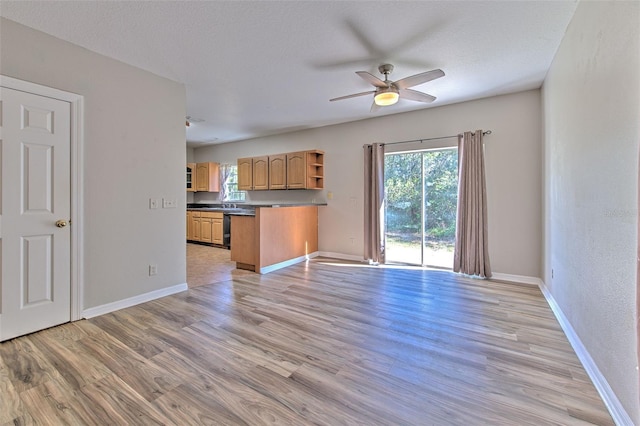 unfurnished living room with a textured ceiling, light hardwood / wood-style floors, and ceiling fan