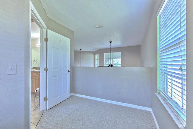 unfurnished room featuring light colored carpet