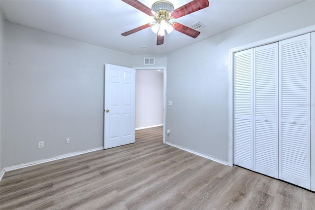 unfurnished bedroom with ceiling fan, a closet, and light hardwood / wood-style flooring