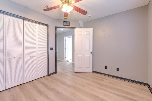 unfurnished bedroom featuring ceiling fan, light hardwood / wood-style floors, and a closet