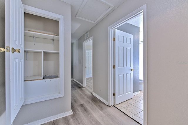 corridor with light hardwood / wood-style floors