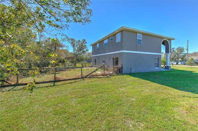 rear view of property with a yard