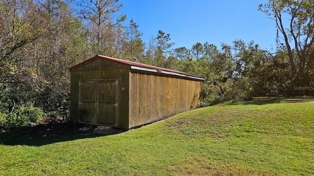 view of outbuilding featuring a yard