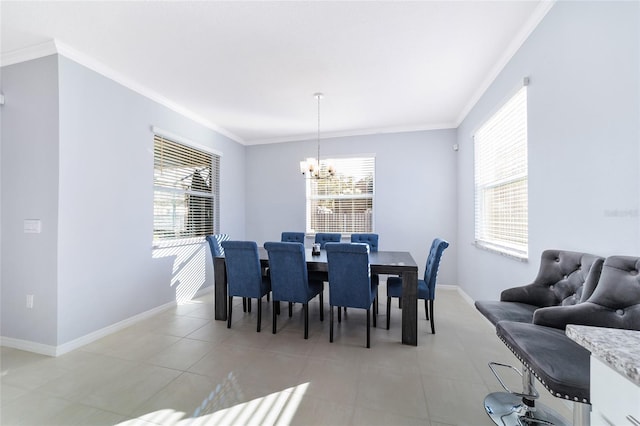 dining room with a wealth of natural light, an inviting chandelier, light tile patterned floors, and ornamental molding