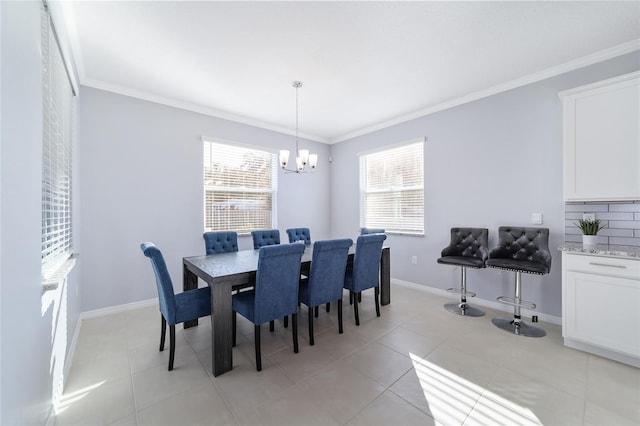 tiled dining room featuring a notable chandelier and ornamental molding