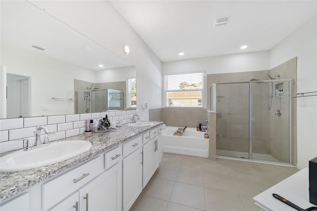 bathroom featuring tile patterned flooring, vanity, backsplash, and independent shower and bath