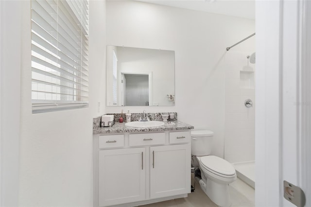 bathroom with vanity, toilet, and walk in shower