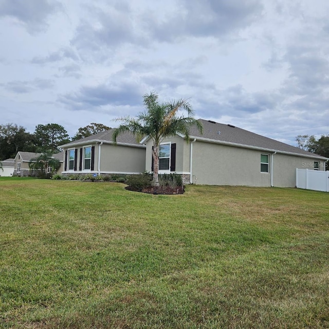 view of property exterior with a yard