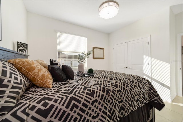 bedroom featuring a closet and light tile patterned floors