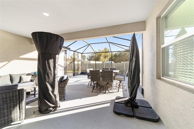 view of patio with glass enclosure and an outdoor living space