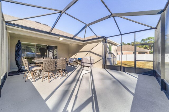 view of patio / terrace featuring a lanai