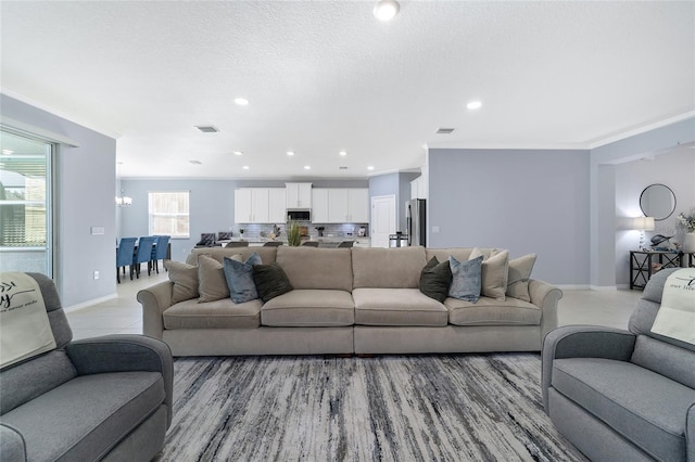 living room featuring a textured ceiling and ornamental molding