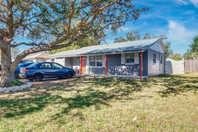 ranch-style home featuring a front yard