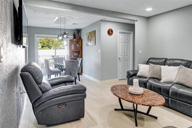 living room featuring a notable chandelier and light tile patterned floors