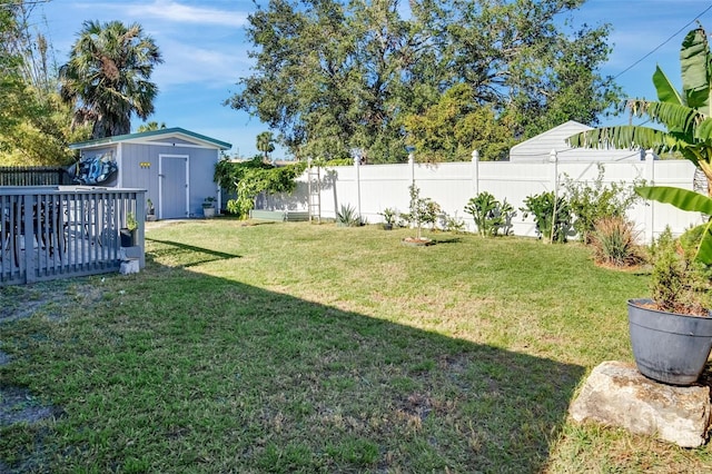 view of yard with a storage shed and a wooden deck