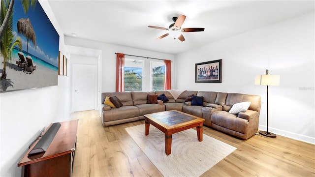 living room featuring ceiling fan and light hardwood / wood-style flooring