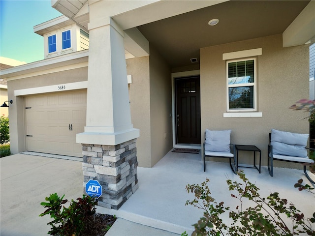 doorway to property with a garage