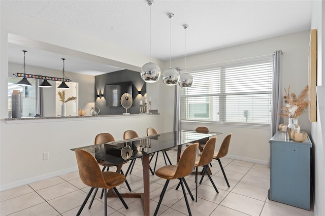 tiled dining area featuring a textured ceiling