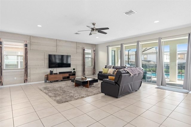 living room featuring ceiling fan and light tile patterned flooring