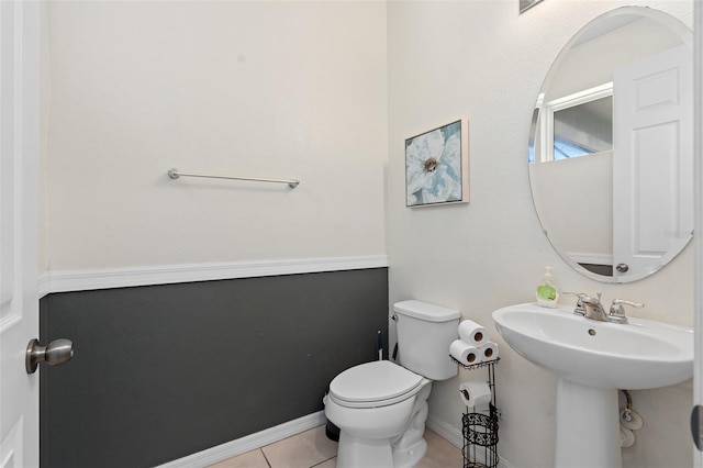 bathroom with tile patterned flooring, toilet, and sink