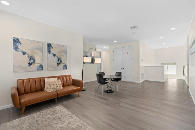 sitting room with wood-type flooring