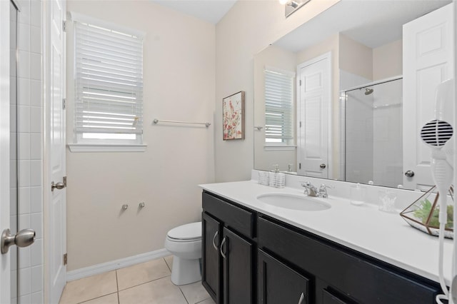 bathroom featuring tile patterned flooring, vanity, a shower with shower door, and toilet