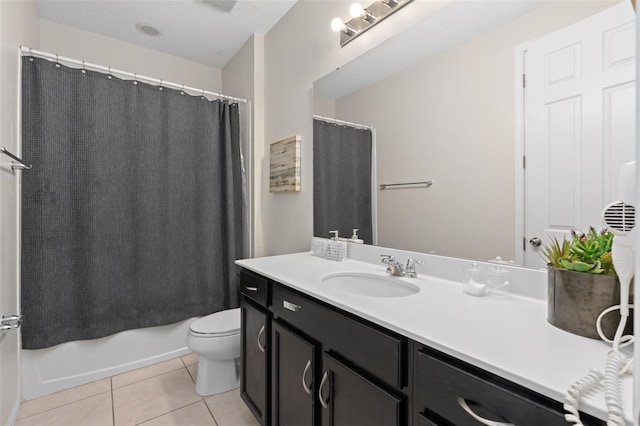 full bathroom with tile patterned floors, a textured ceiling, vanity, shower / bath combo with shower curtain, and toilet