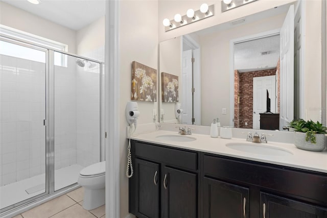 bathroom with toilet, tile patterned flooring, vanity, and walk in shower