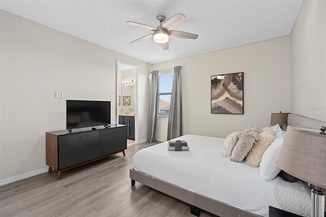 bedroom featuring light hardwood / wood-style flooring, ensuite bath, and ceiling fan