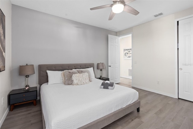 bedroom with light hardwood / wood-style flooring and ceiling fan