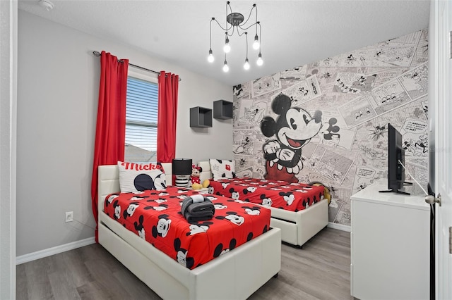 bedroom featuring hardwood / wood-style floors and a textured ceiling