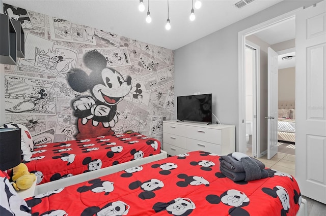 tiled bedroom featuring ensuite bathroom