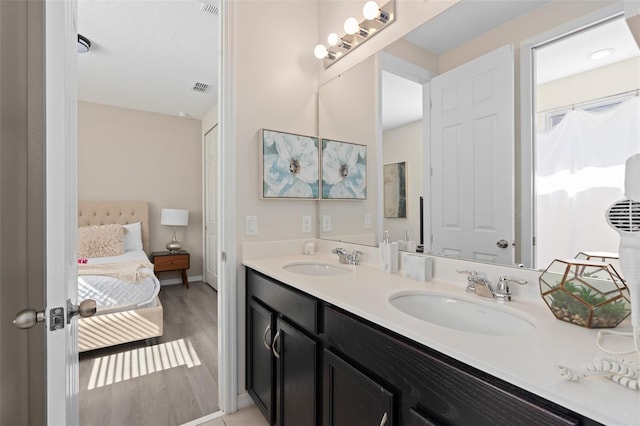 bathroom with vanity and wood-type flooring