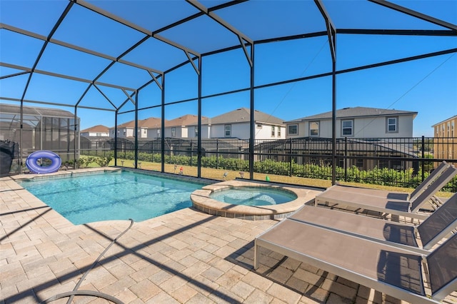 view of pool featuring a lanai, an in ground hot tub, and a patio