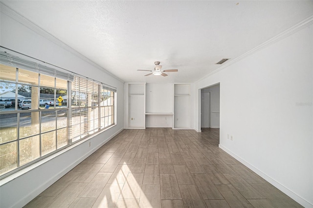 unfurnished room with wood-type flooring, a textured ceiling, ceiling fan, and crown molding