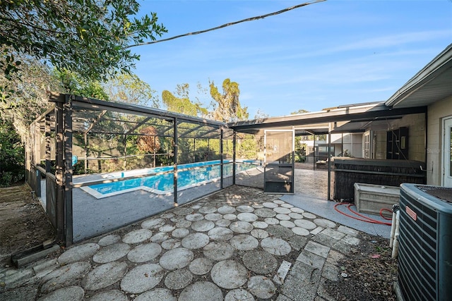 view of patio featuring a lanai and central AC