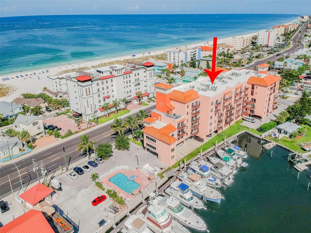 birds eye view of property with a water view and a view of the beach