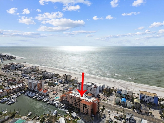 birds eye view of property featuring a water view and a beach view