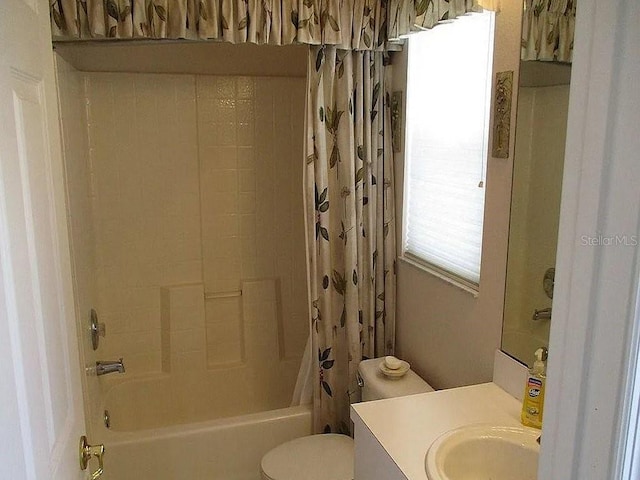 full bathroom featuring shower / bath combination with curtain, toilet, and vanity