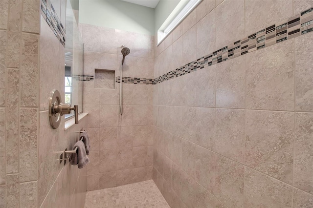 bathroom with tiled shower