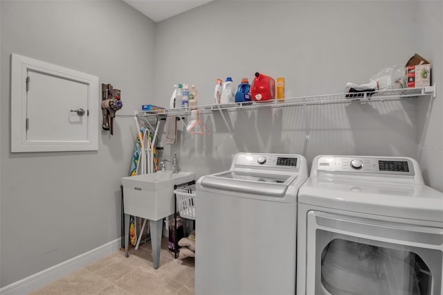 laundry area with light tile patterned floors and separate washer and dryer