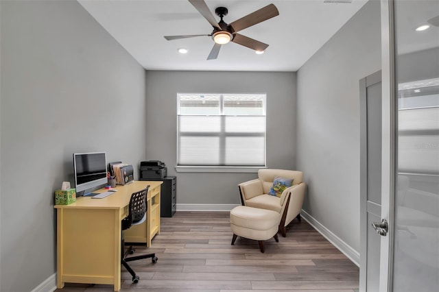 office space with light wood-type flooring and ceiling fan