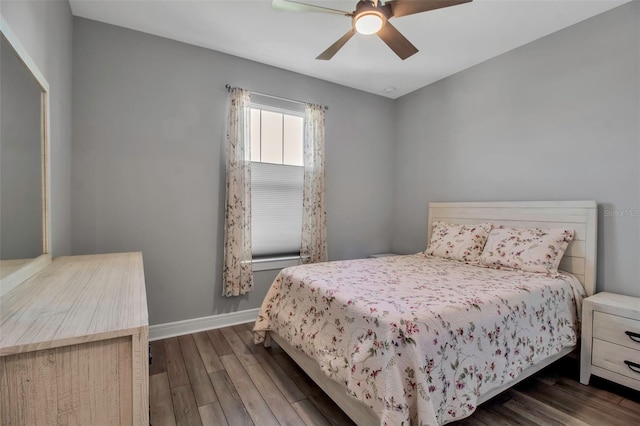 bedroom with ceiling fan and dark hardwood / wood-style flooring