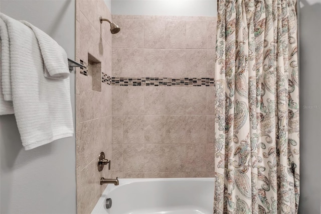 bathroom with shower / bath combination with curtain