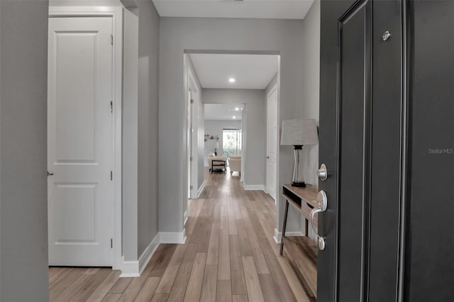 hallway with light hardwood / wood-style floors