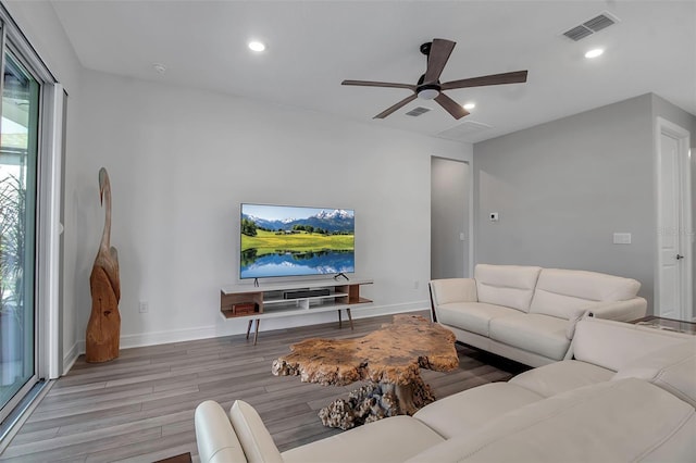 living room featuring ceiling fan and light hardwood / wood-style floors